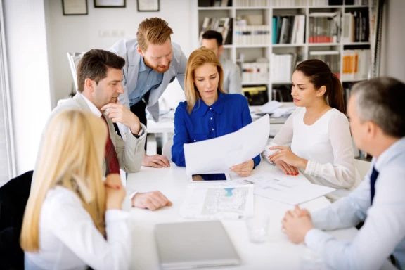 Team looking at papers at table