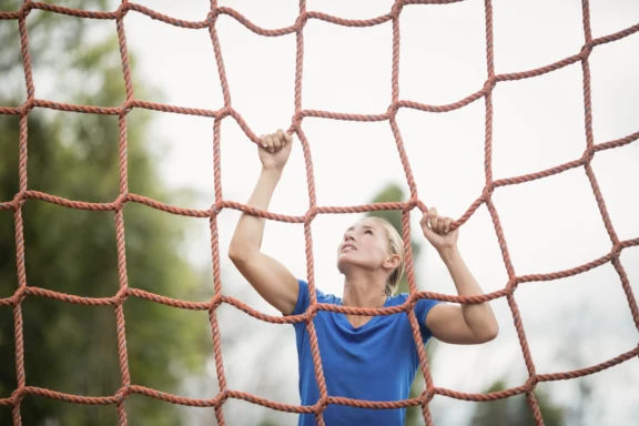 woman climbing a net